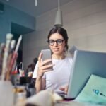 woman in white shirt using smartphone